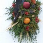 A traditional Colonial Williamsburg Christmas wreath decorated with fruits